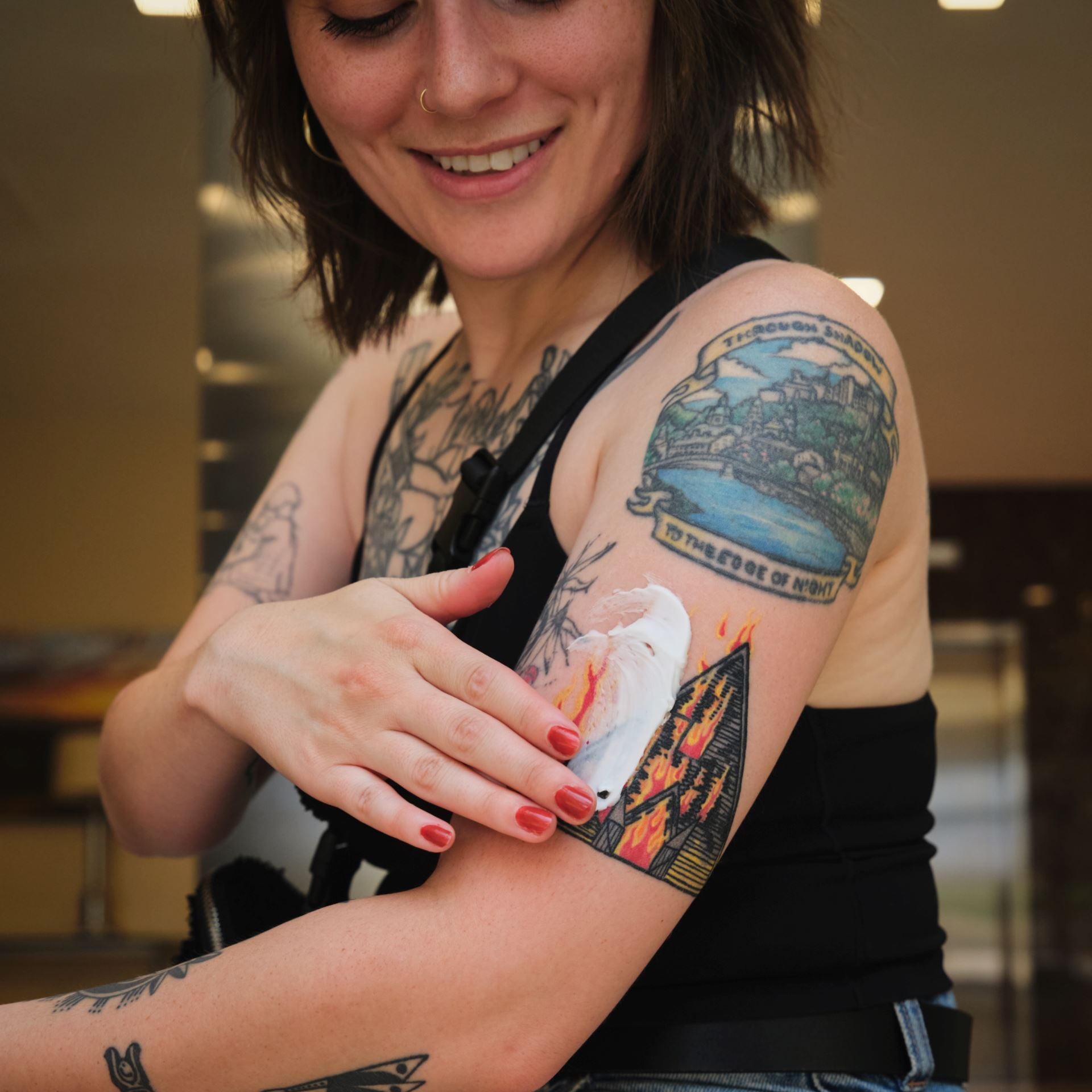 Daily Tattoo Lotion (12.0 oz) Saniderm Tattoo Aftercare  being rubbed into tattooed skin